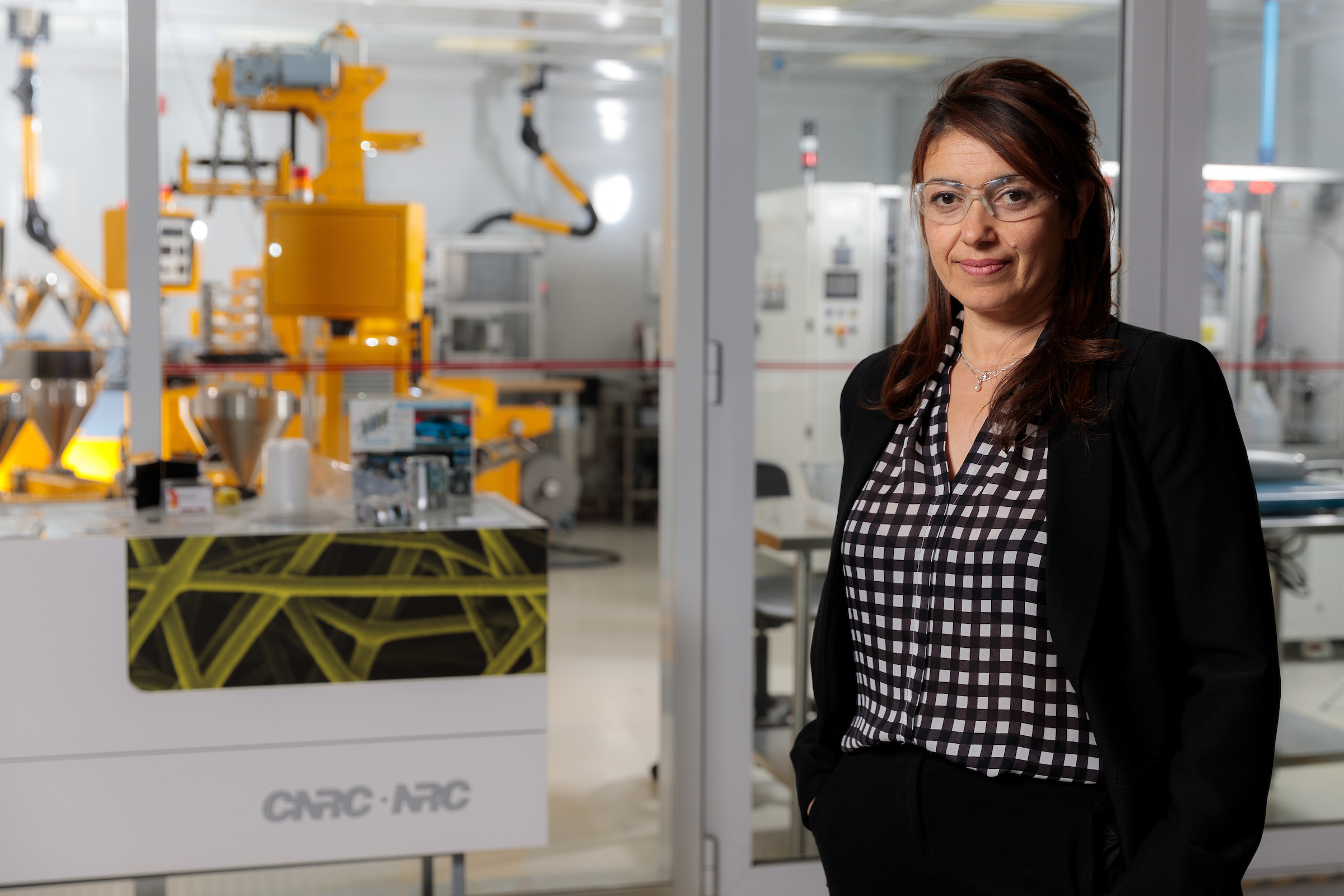woman standing in front of a large machine