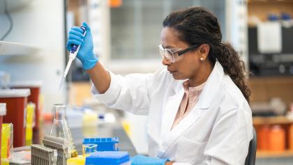 woman in lab coat performs a test from the article Canada needs a national strategy for early cancer diagnosis