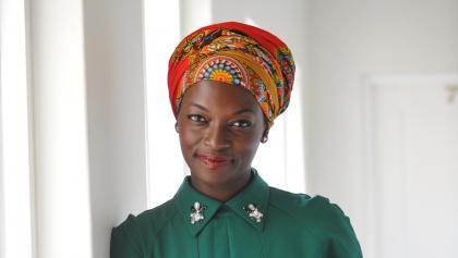 woman in green shirt and colourful head wrap from the article ‘She waged a war’: A daughter’s intimate look at Nigeria’s most-decorated figure